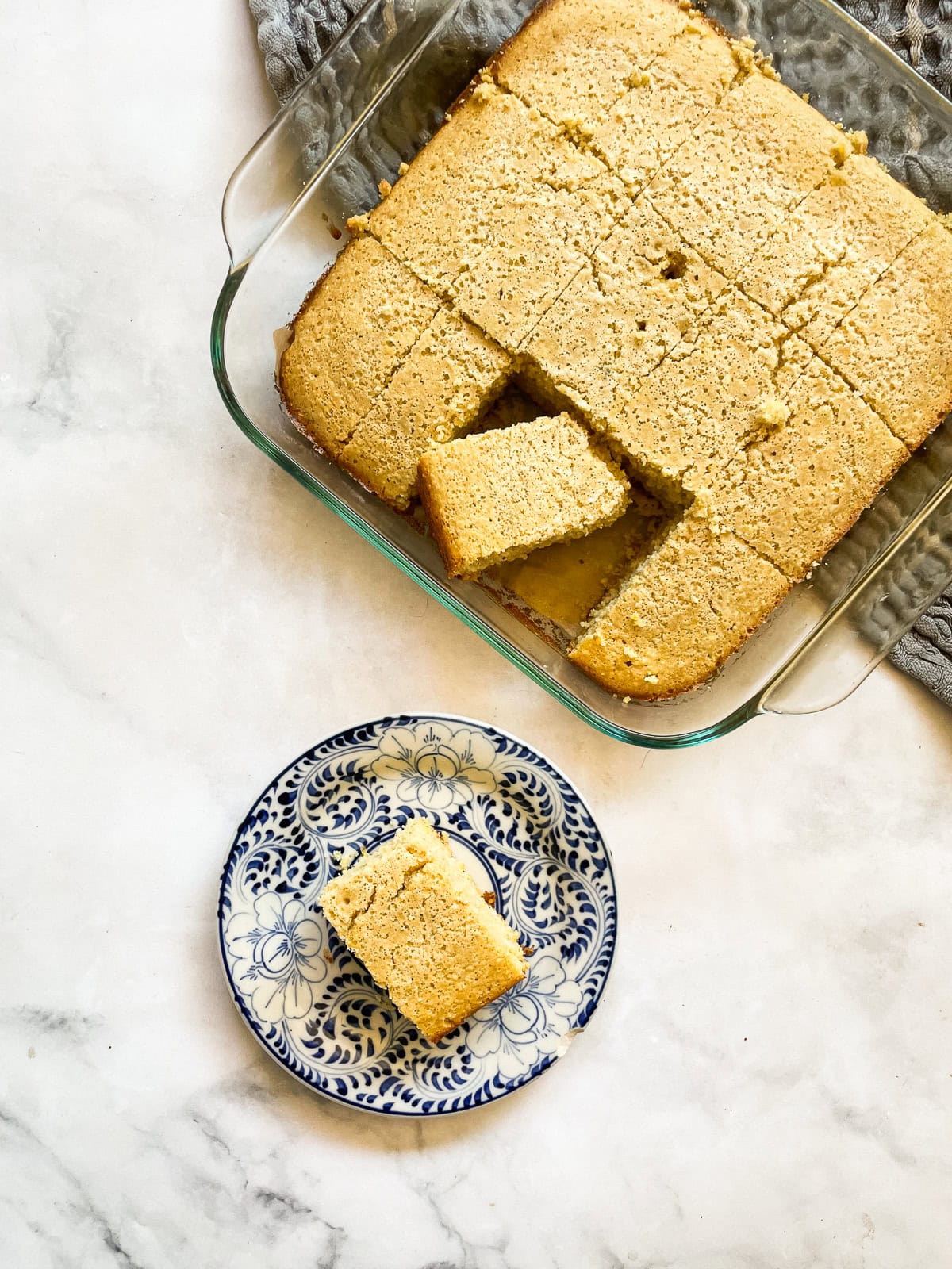 Squares of almond flour cornbread and one on a plate.