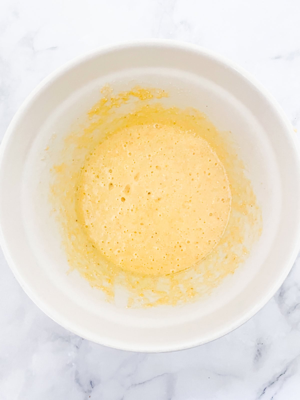 Easy, gluten-free almond flour cornbread is made with a combo of almond flour and cornmeal. Wonderful with soups, stews, chili, and more. The batter for almond flour cornbread in a bowl.