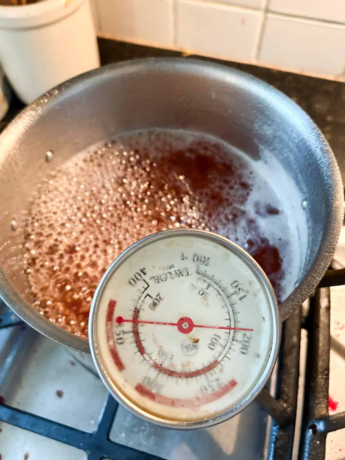 Glossy, sweetly fragrant apple jelly is a special way to make great use of seasonal fruit. Can or refrigerate this beautiful homemade preserve. Apple jelly reaches setting stage on a thermometer.