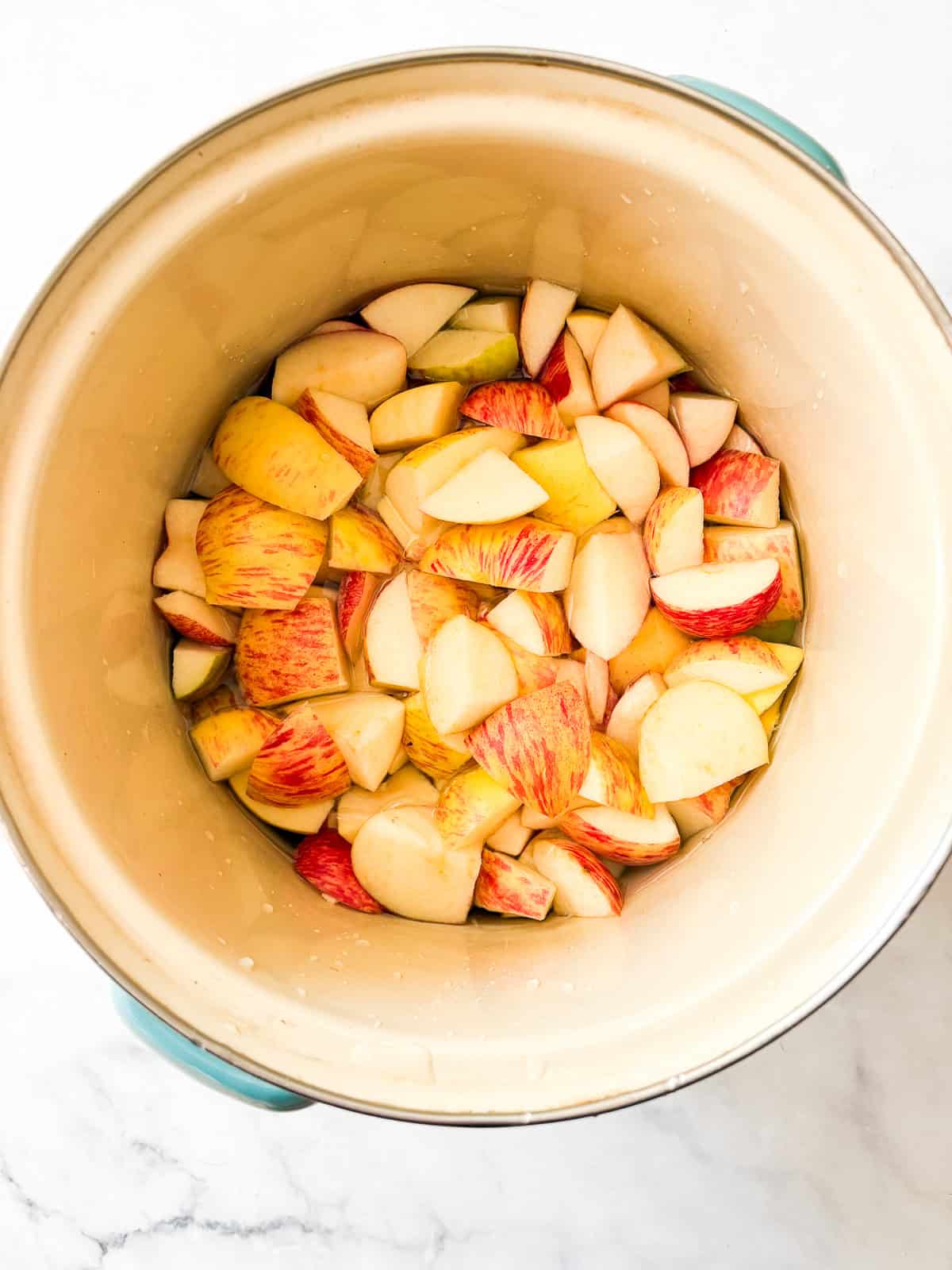 Glossy, sweetly fragrant apple jelly is a special way to make great use of seasonal fruit. Can or refrigerate this beautiful homemade preserve. Apples are cooked in water.