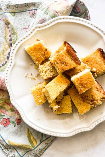 A plate of almond flour cornbread squares on a napkin.