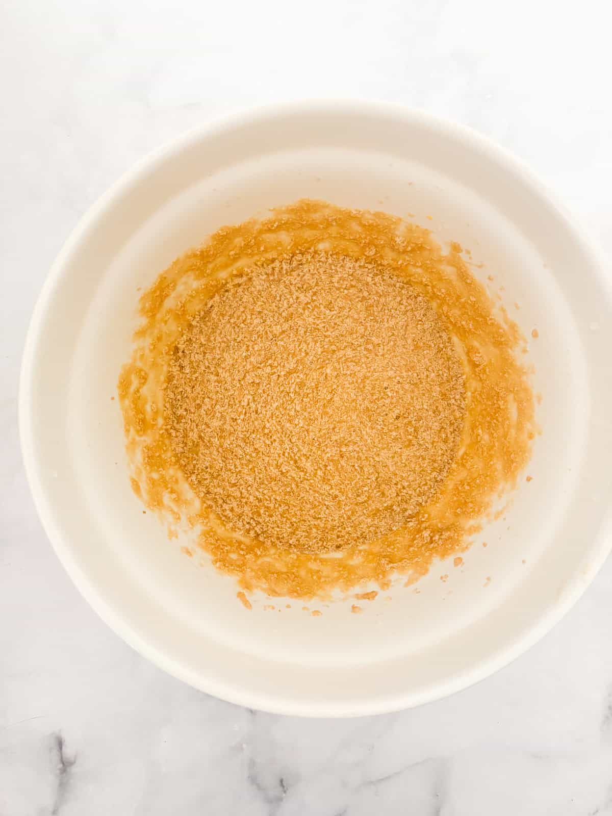 Darkly sweet and studded with walnuts, a gluten free applesauce cake equals homey comfort. Make it with homemade applesauce if you can. Eggs and applesauce added to the creamed butter mixture.