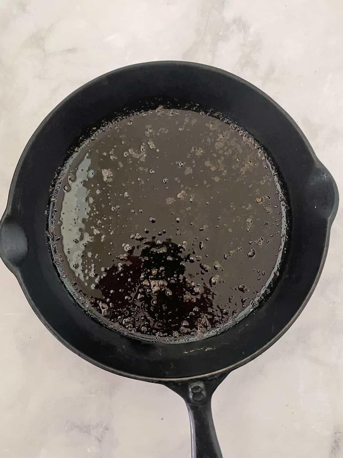 This gluten-free maple cornbread is tender-crumbed perfection thanks to buttermilk. Naturally sweetened with pure maple syrup! Melted butter in a cast iron pan.