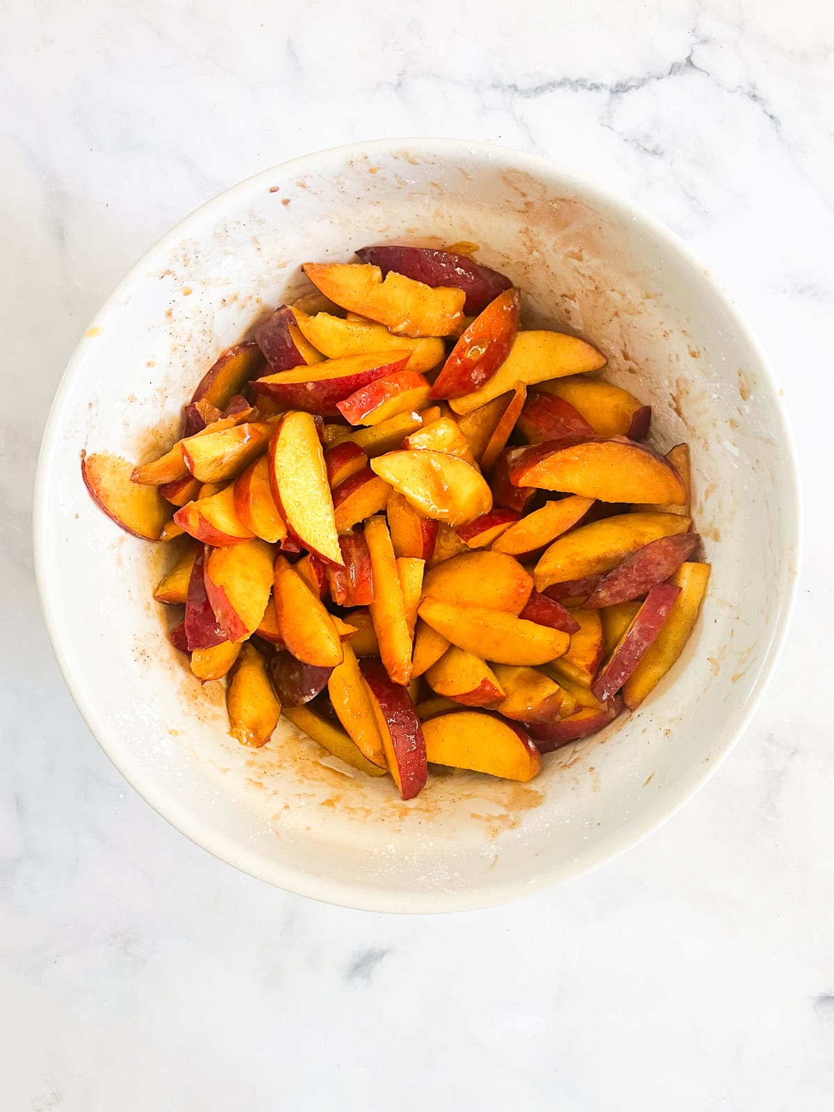 This beautifully simple gluten free nectarine crisp highlights ripe summer stone fruit. Add fresh rosemary for a lovely herbal touch. Nectarines are mixed with sugar and cinnamon for crisp.