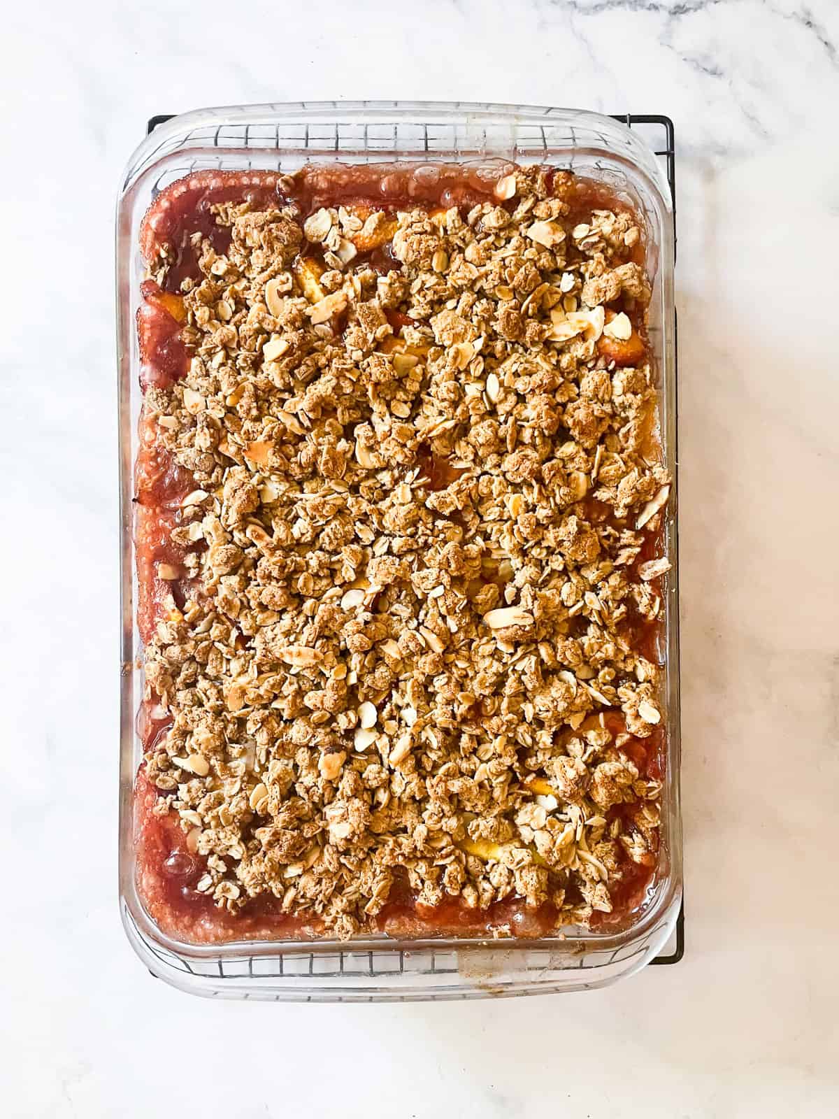 This beautifully simple gluten free nectarine crisp highlights ripe summer stone fruit. Add fresh rosemary for a lovely herbal touch. A baked gluten free nectarine crisp cools in the pan.