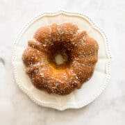 Sugar and cinnamon added to a bundt cake.