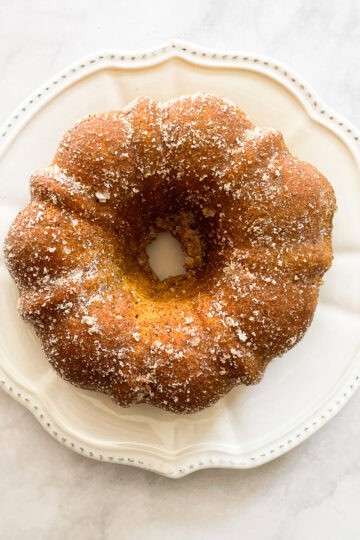 Sugar and cinnamon added to a bundt cake.