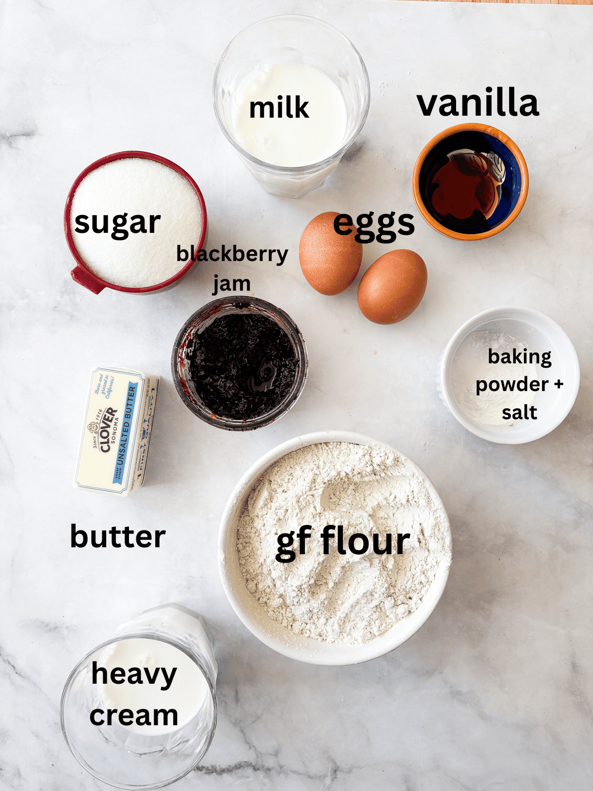 A tender gluten-free blackberry jam cake layered with whipped cream and jam that's fresh, light, and perfect for summer. Ingredients for gluten free blackberry jam cake are text-labeled.