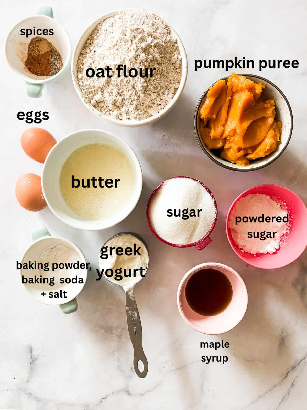 A soft, fluffy, and warmly spiced oat flour pumpkin cake that's topped with a slick of sweet maple glaze. Naturally gluten-free! Ingredients for oat flour pumpkin cake are text-labeled.