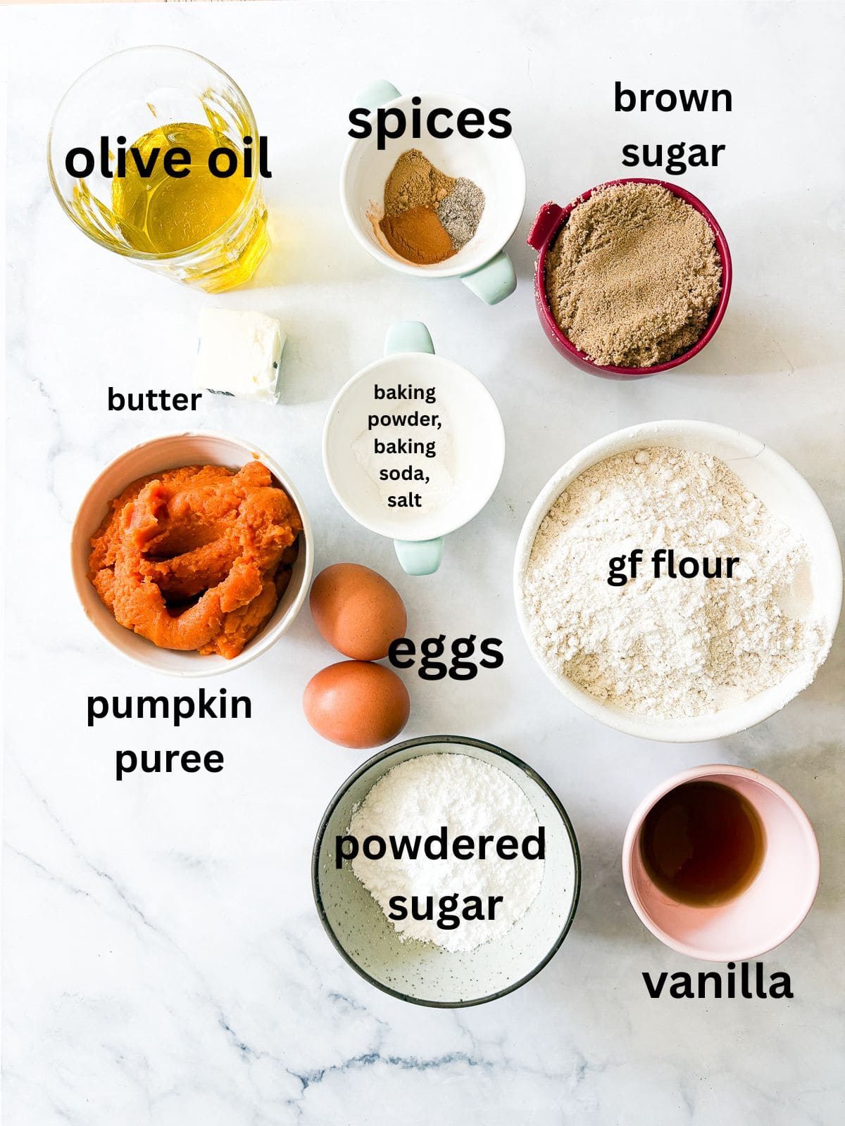 A thick maple glaze tops a soft gluten free pumpkin olive oil cake that's dairy-free, made in one bowl, and utterly delicious! The ingredients for a gluten free pumpkin olive oil cake are text-labeled and portioned.