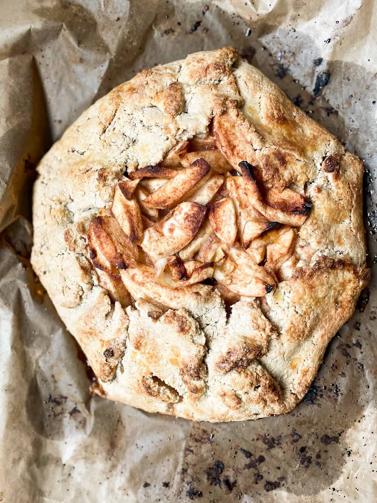 Rustic and beautiful, this gluten free apple galette wraps juicy, spiced apples in a buttery, flaky crust. Perfect for holiday gatherings! A gluten free apple galette cools.