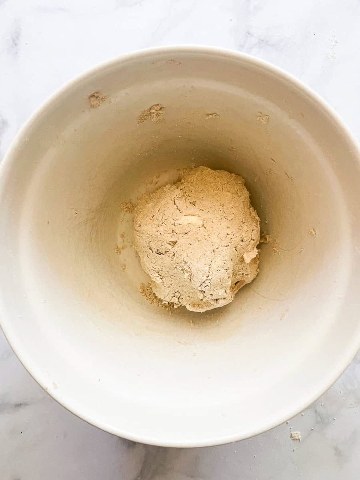 Rustic and beautiful, this gluten free apple galette wraps juicy, spiced apples in a buttery, flaky crust. Perfect for holiday gatherings! A ball of gluten-free crust in a bowl.