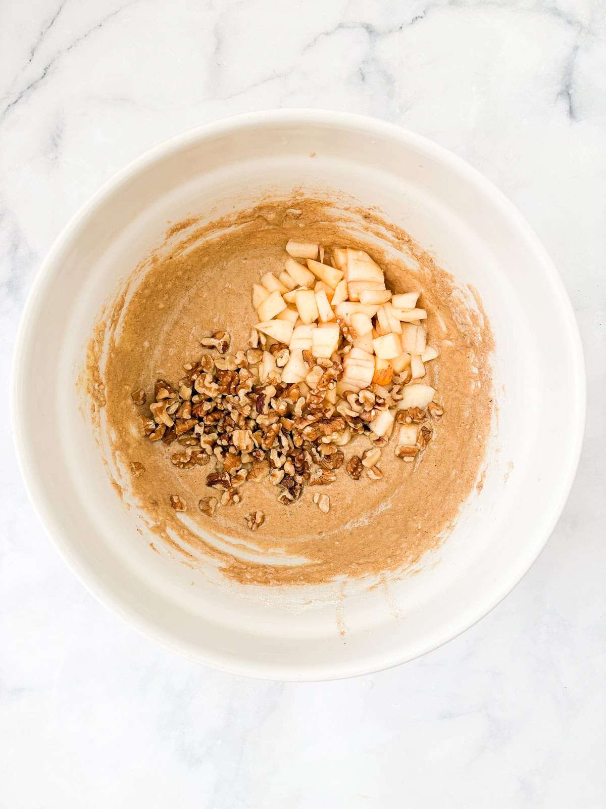 This beautifully simple yet deeply satisfying gluten free banana apple bread marries a classic banana bread with fresh for a twist. Apples and walnuts stirred into banana bread batter.