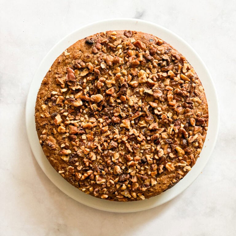 Chopped walnuts top a gluten free banana walnut cake.