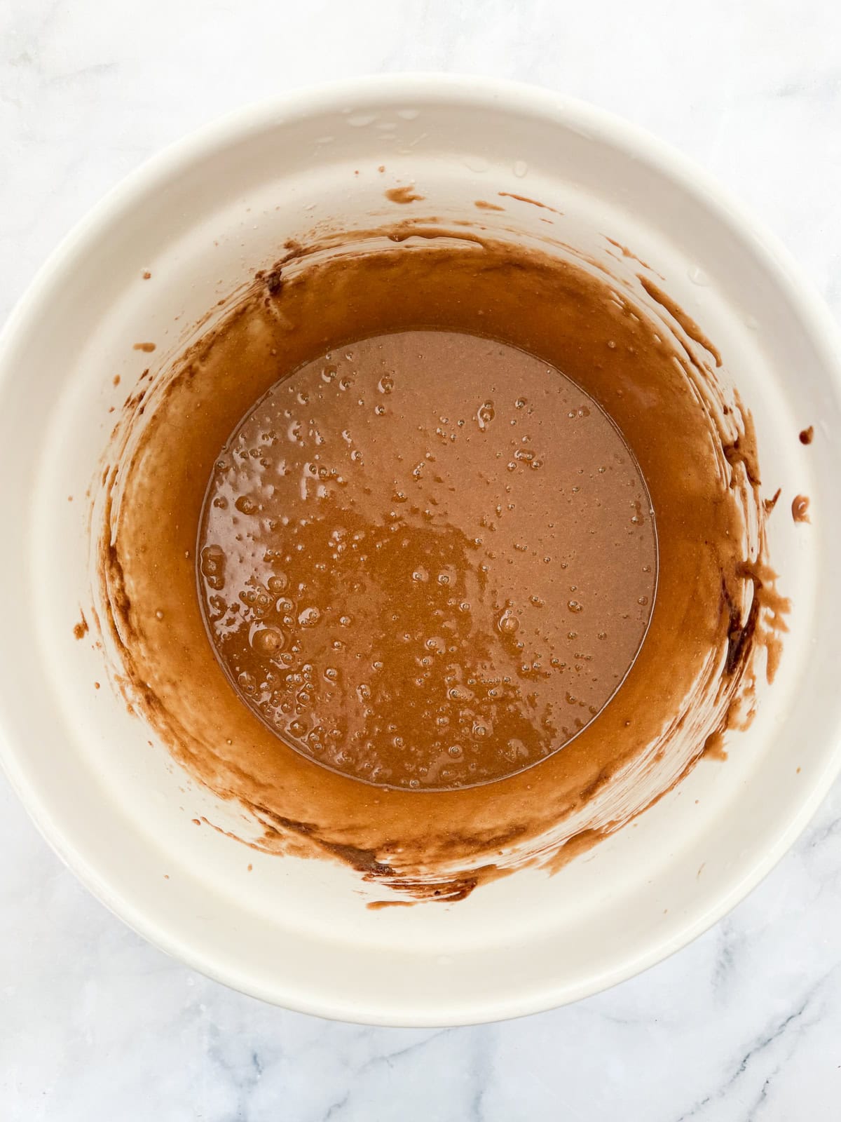 This gluten free chocolate cake with caramel frosting is rich, tender, and deeply chocolatey, perfect for birthdays or any celebration. Gluten free chocolate cake batter in a bowl.