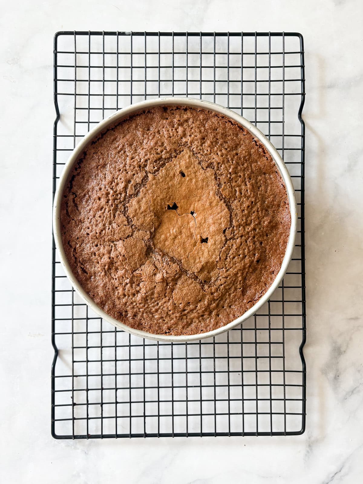 This gluten free chocolate cake with caramel frosting is rich, tender, and deeply chocolatey, perfect for birthdays or any celebration. A gluten free chocolate cake cools in the pan.