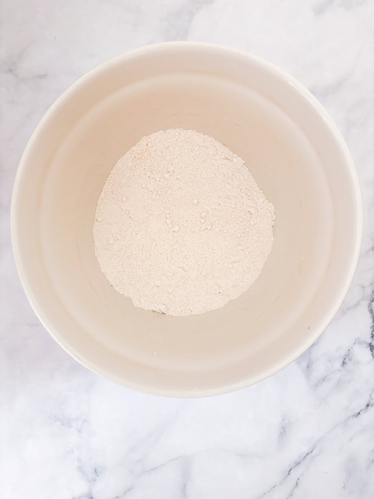 This gluten free chocolate cake with caramel frosting is rich, tender, and deeply chocolatey, perfect for birthdays or any celebration. Flour mix for a gluten free chocolate cake in a bowl.