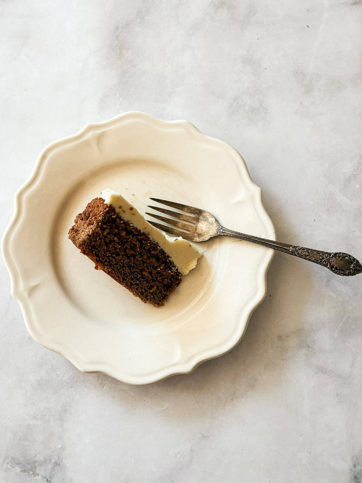 This gluten free chocolate cake with caramel frosting is rich, tender, and deeply chocolatey, perfect for birthdays or any celebration. A slice of gluten free chocolate cake with caramel frosting on its side on a plate.