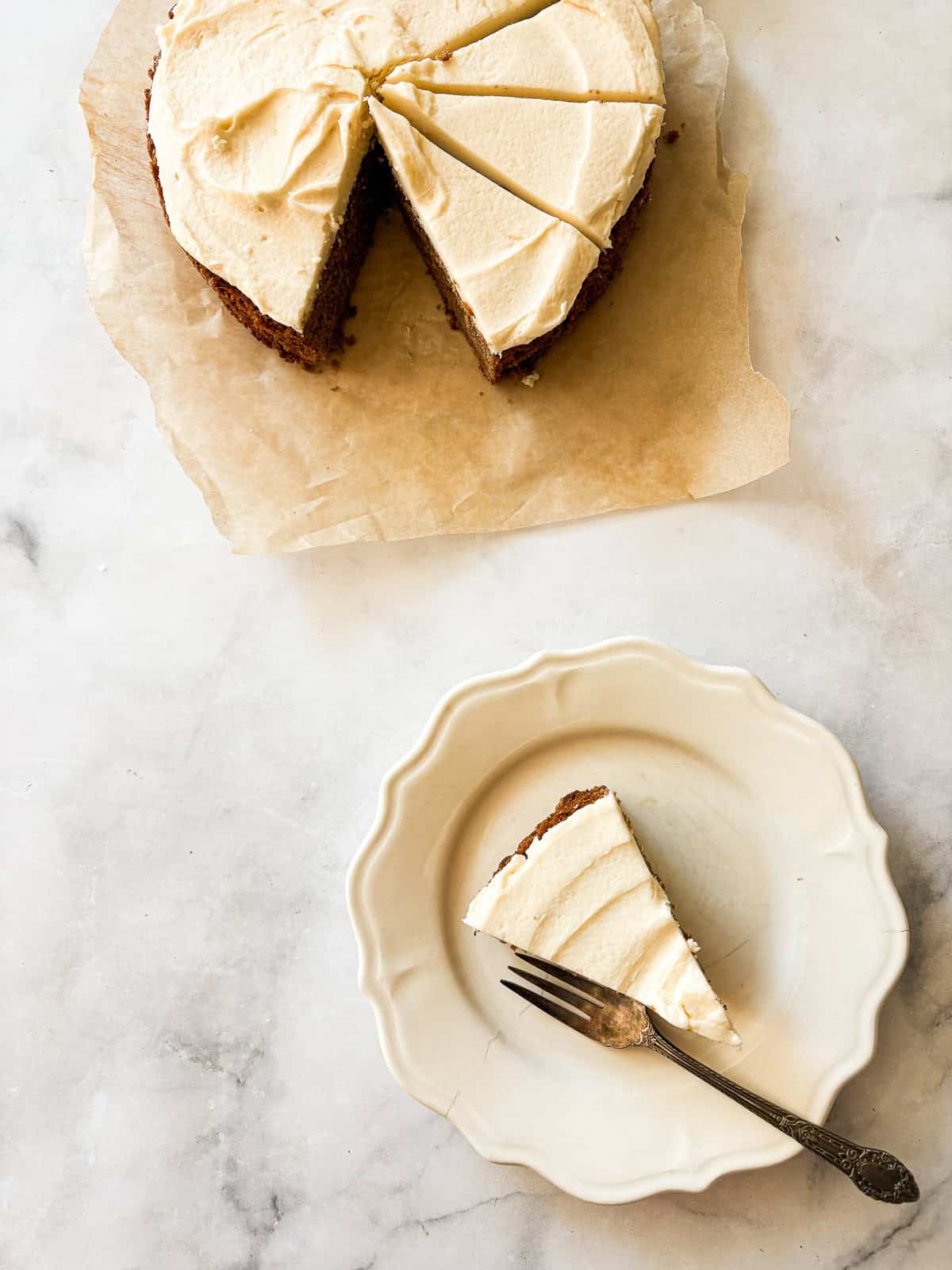 This gluten free chocolate cake with caramel frosting is rich, tender, and deeply chocolatey, perfect for birthdays or any celebration. A slice of gluten free chocolate cake with caramel icing next to the cake.