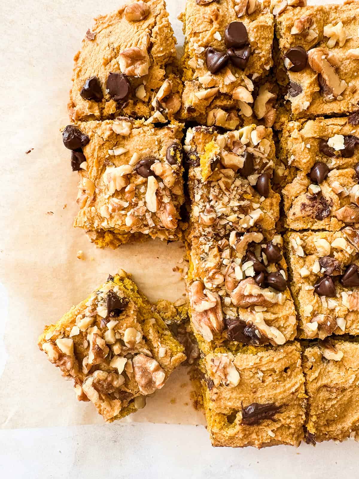 A gluten free pumpkin blondie square next to more blondies.