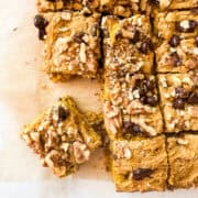 A gluten free pumpkin blondie square next to more blondies.