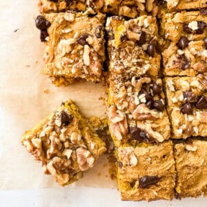 A gluten free pumpkin blondie square next to more blondies.