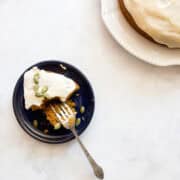 A fork cuts into a piece of gluten free pumpkin olive oil cake.