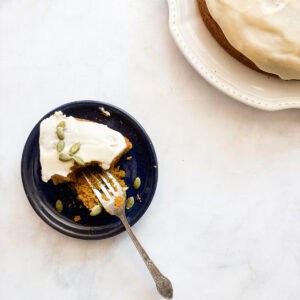 A fork cuts into a piece of gluten free pumpkin olive oil cake.