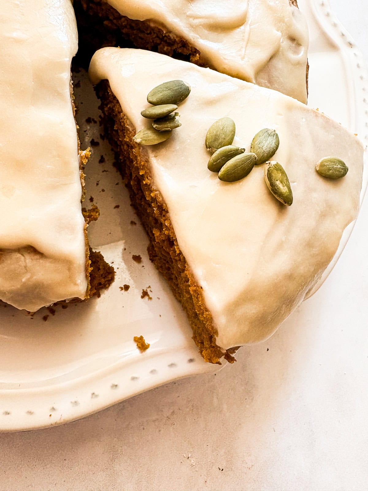 Pumpkin seeds on a slice of pumpkin olive olil cake.