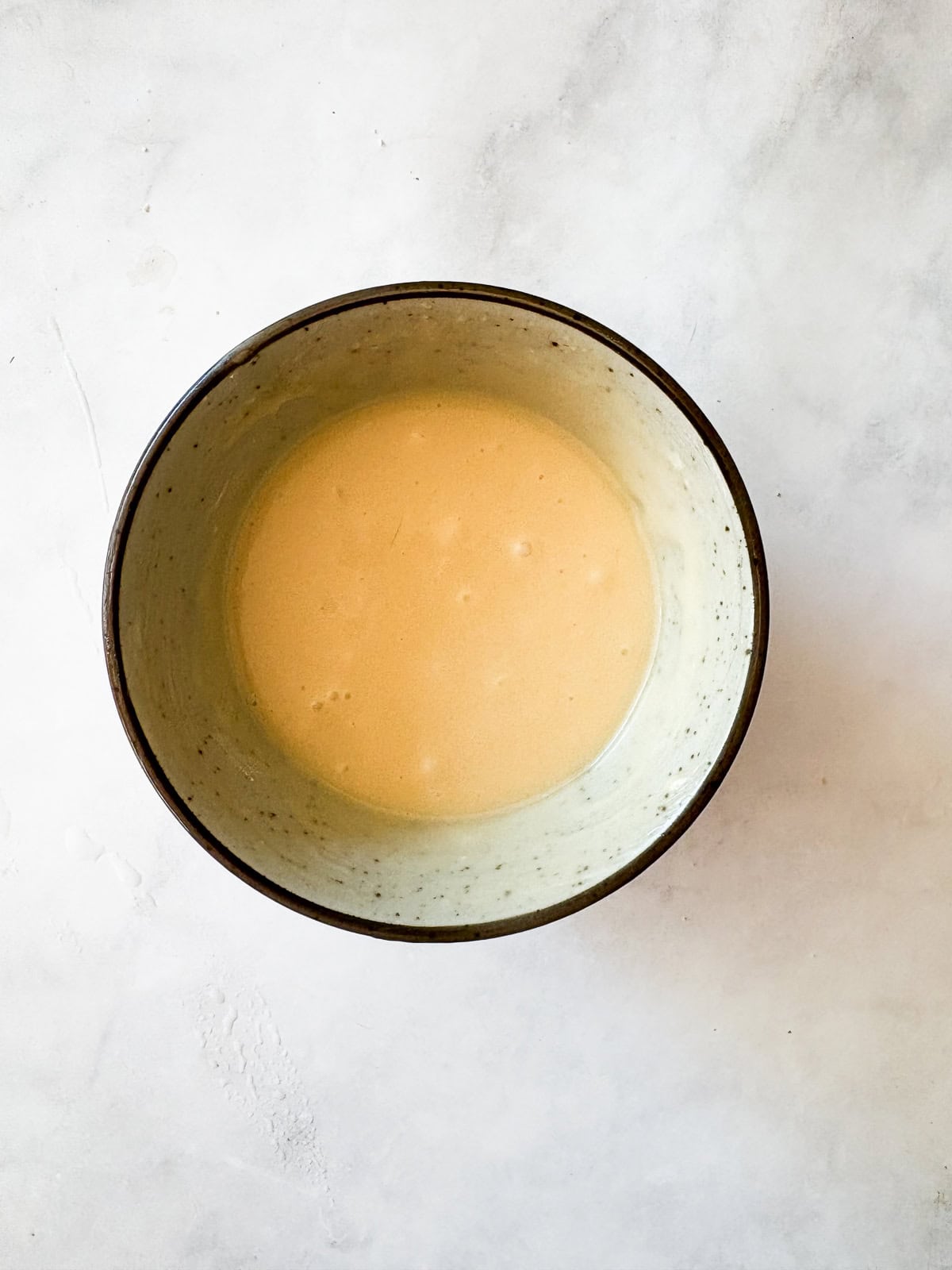 This smooth and luxurious maple glaze recipe needs just three simple ingredients to make and is wonderful on scones, pumpkin bread, and more. Powdered sugar is whisked into melted butter and maple syrup.