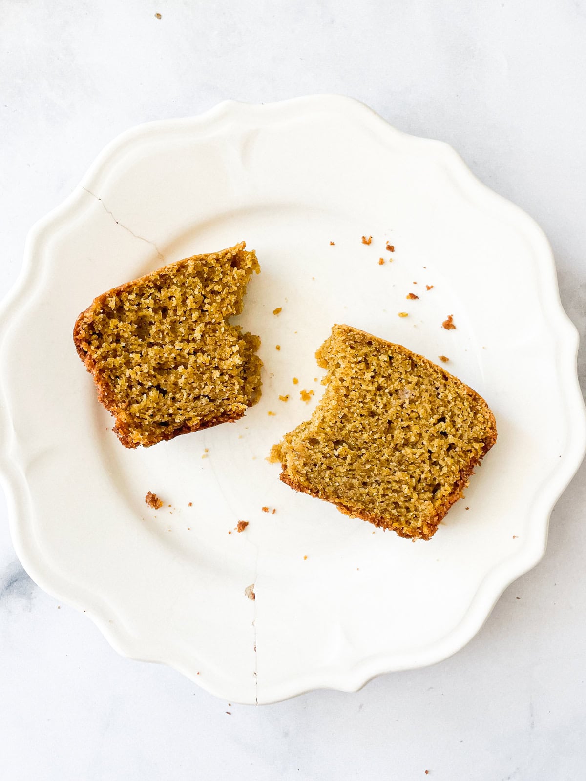 Pieces of oat flour pumpkin bread on a white plate.