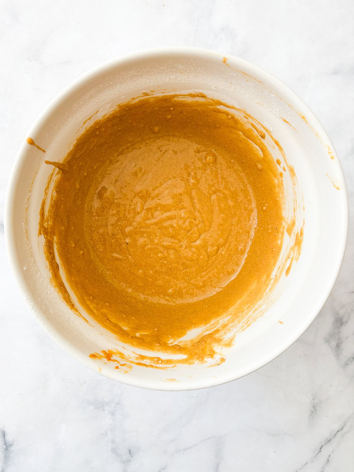 The batter for oat flour pumpkin bread in a bowl.