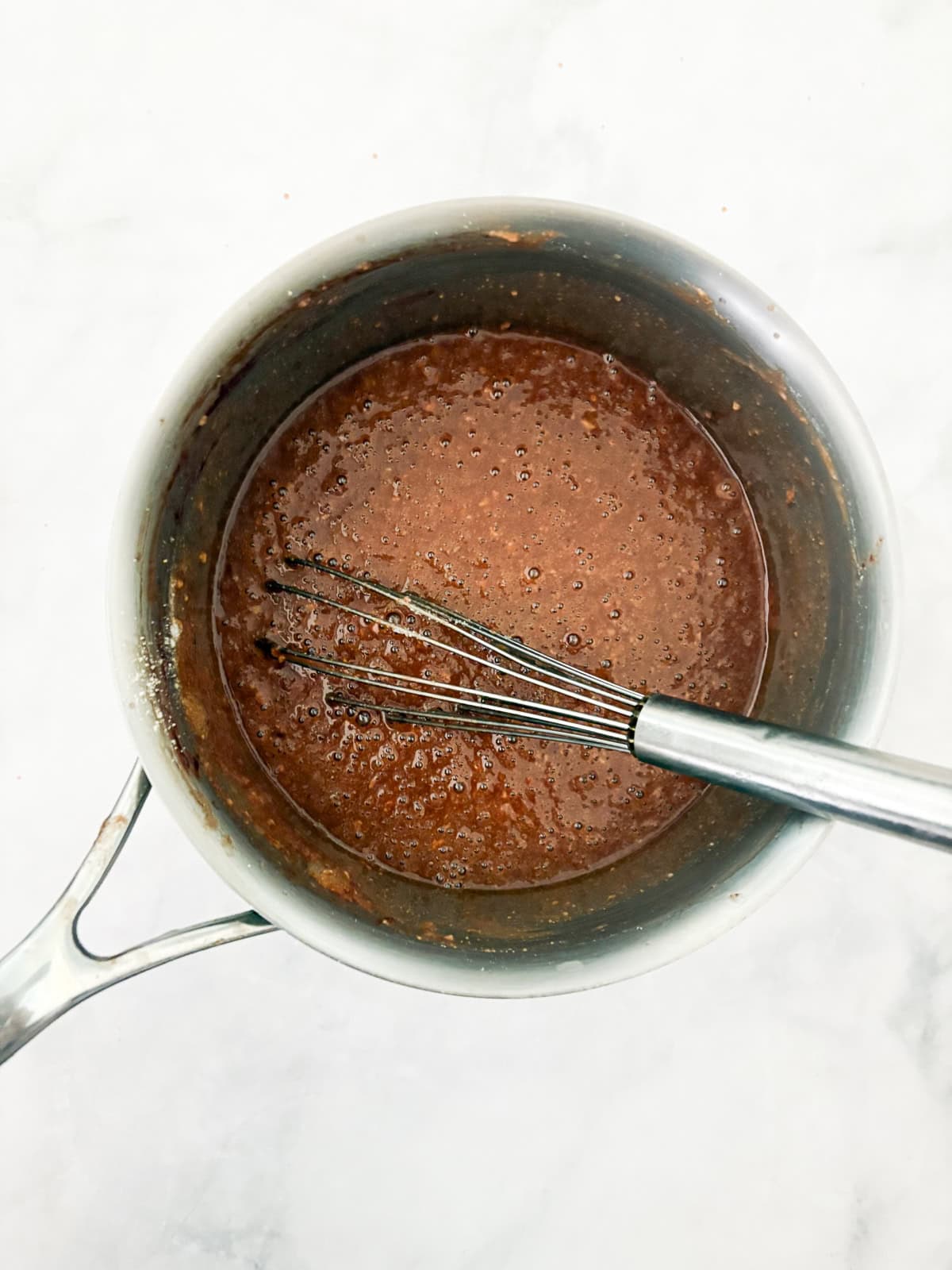 This gluten-free chocolate dump cake hits all the notes you want in a gluten-free cake - fudgy crumb, dense chocolate flavor, and creamy icing. Dry mix is whisked into the chocolate mix in a pot for chocolate dump cake.