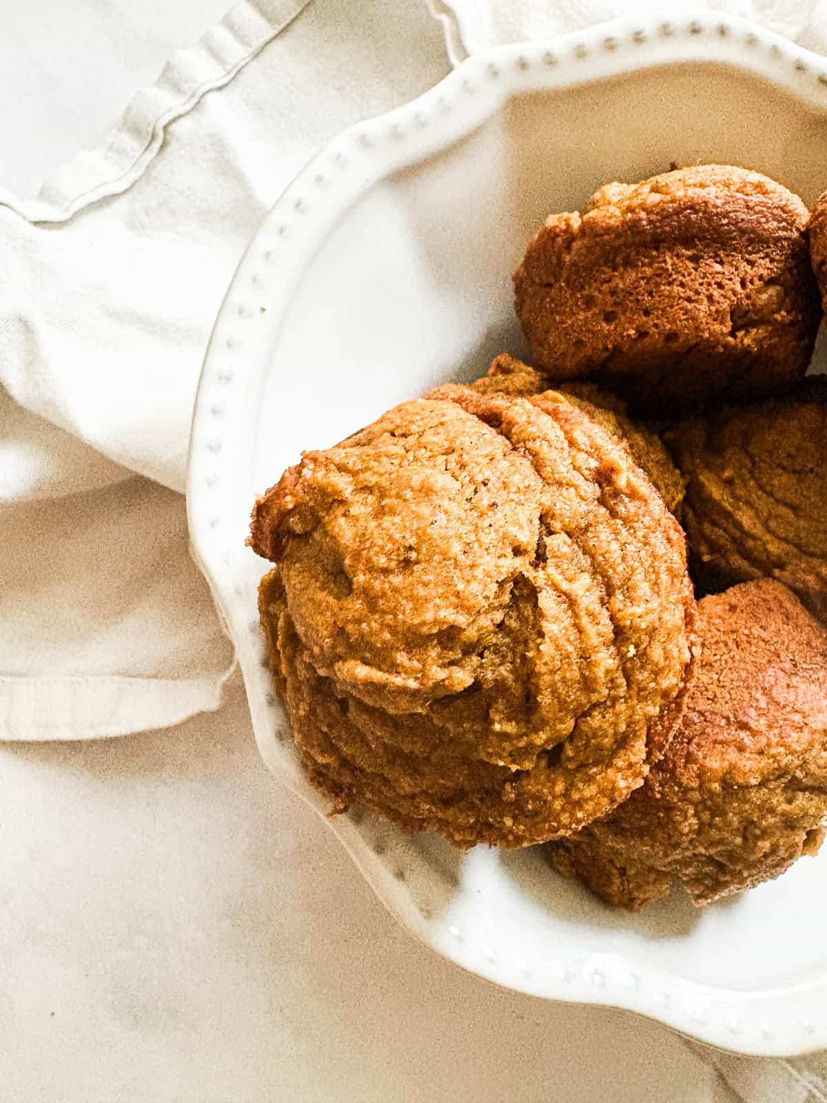 Fluffy maple pumpkin muffins in a bowl.
