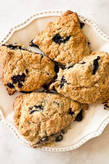 A plate of four gluten free blueberry scones.