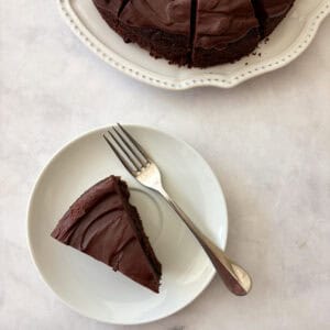 A plate with a slice of gluten free olive oil cake and a fork.