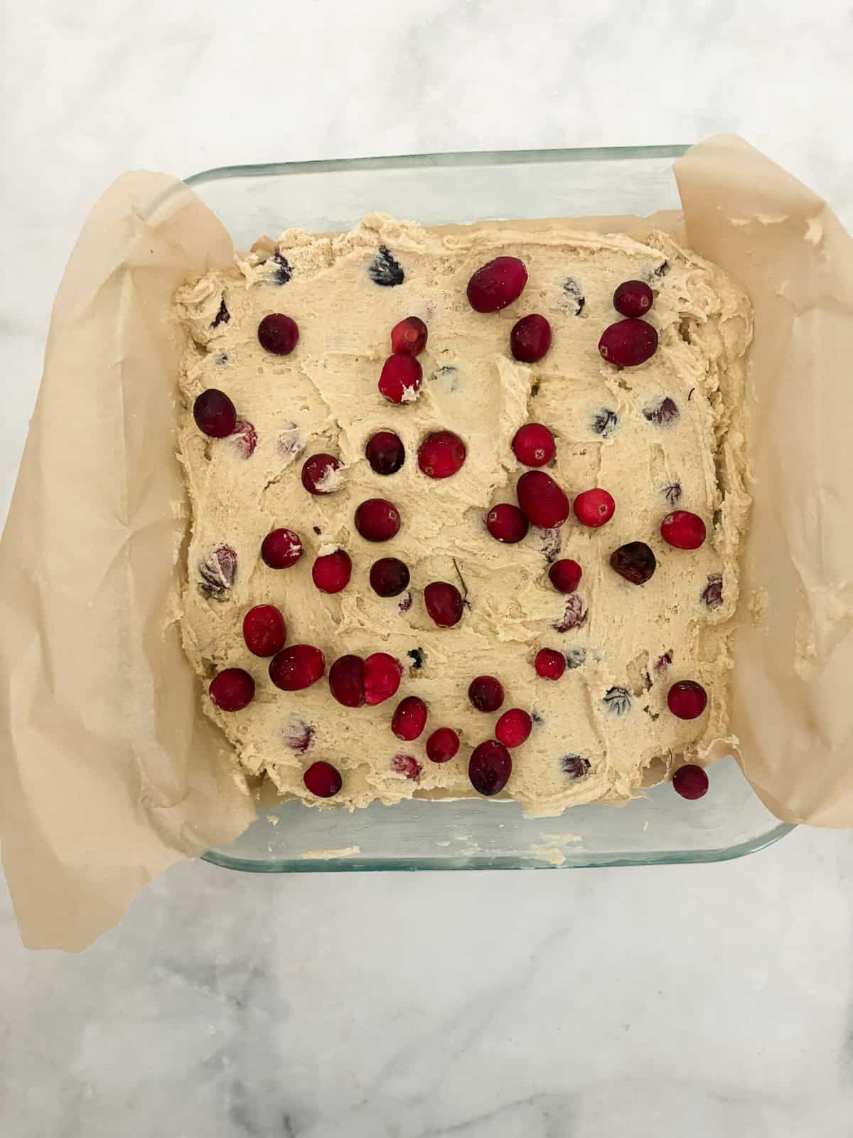 This beautifully festive gluten free cranberry cake is packed with juicy, tart berries that are balanced by a sweet, buttery cake. Cranberries added to the cake batter.