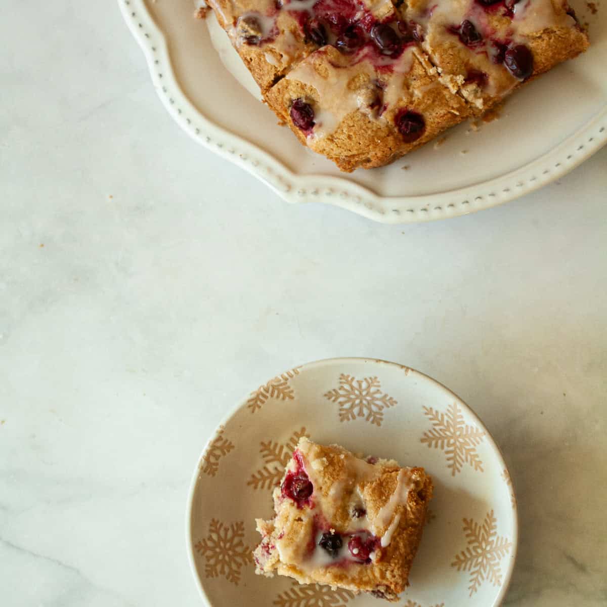 Studded with juicy berries, this sweet and soft cranberry cake is a lovely holiday bake. Great with brunch, or as dessert with ice cream.