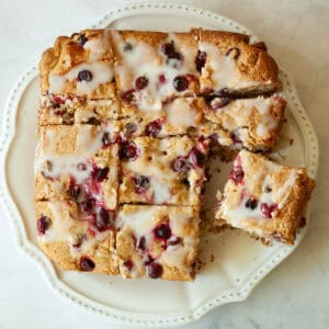 A gluten free cranberry cake cut into squares.