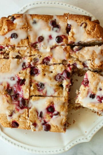 A gluten free cranberry cake cut into squares.