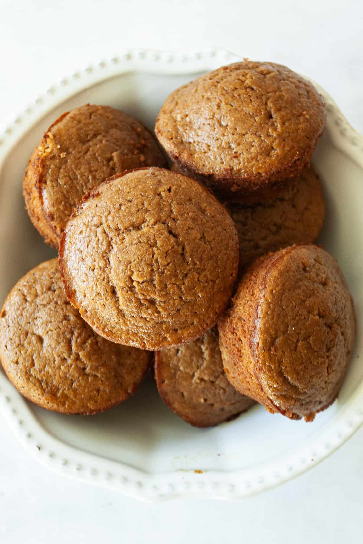 Warmly spiced gluten-free gingerbread muffins take everything you love about classic gingerbread and turn it into a handheld snack! A bowl of gluten free gingerbread muffins.