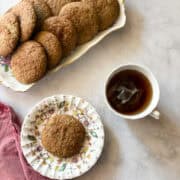 A cup of tea next to gluten free snickerdoodles.