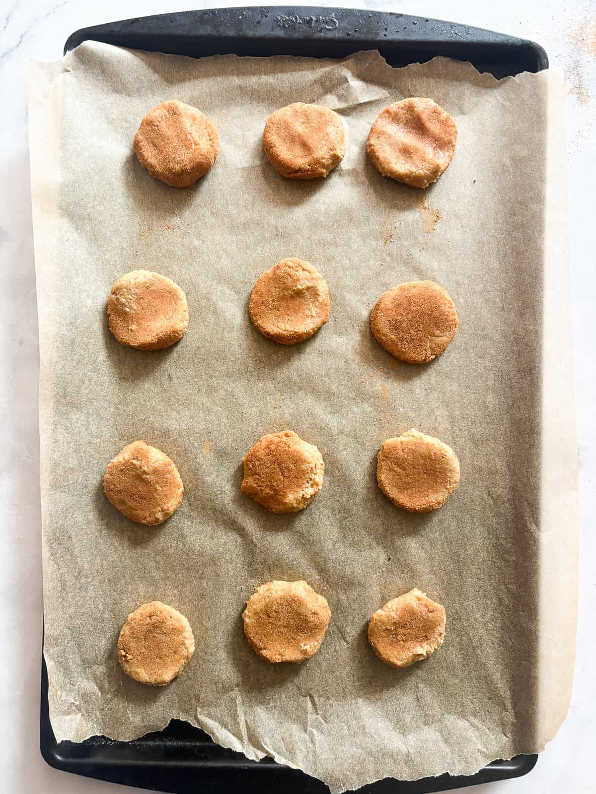 Press the gluten free snickerdoodles dough down.