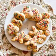 A plate of befanini cookies topped with sprinkles.