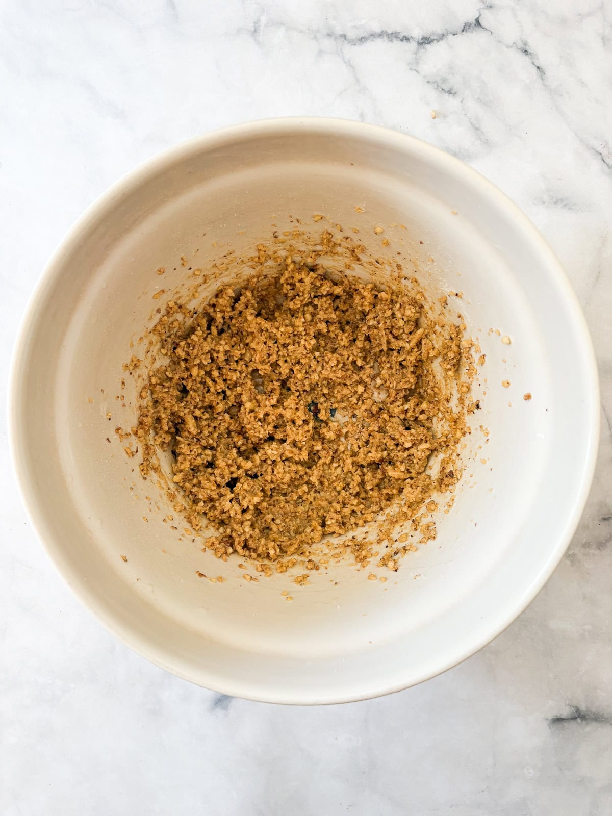 Chewy Moroccan ghriba cookies with walnuts and cinnamon are lightly sweet, rolled in powdered sugar, and easily gluten-free. Ghriba batter in a bowl.