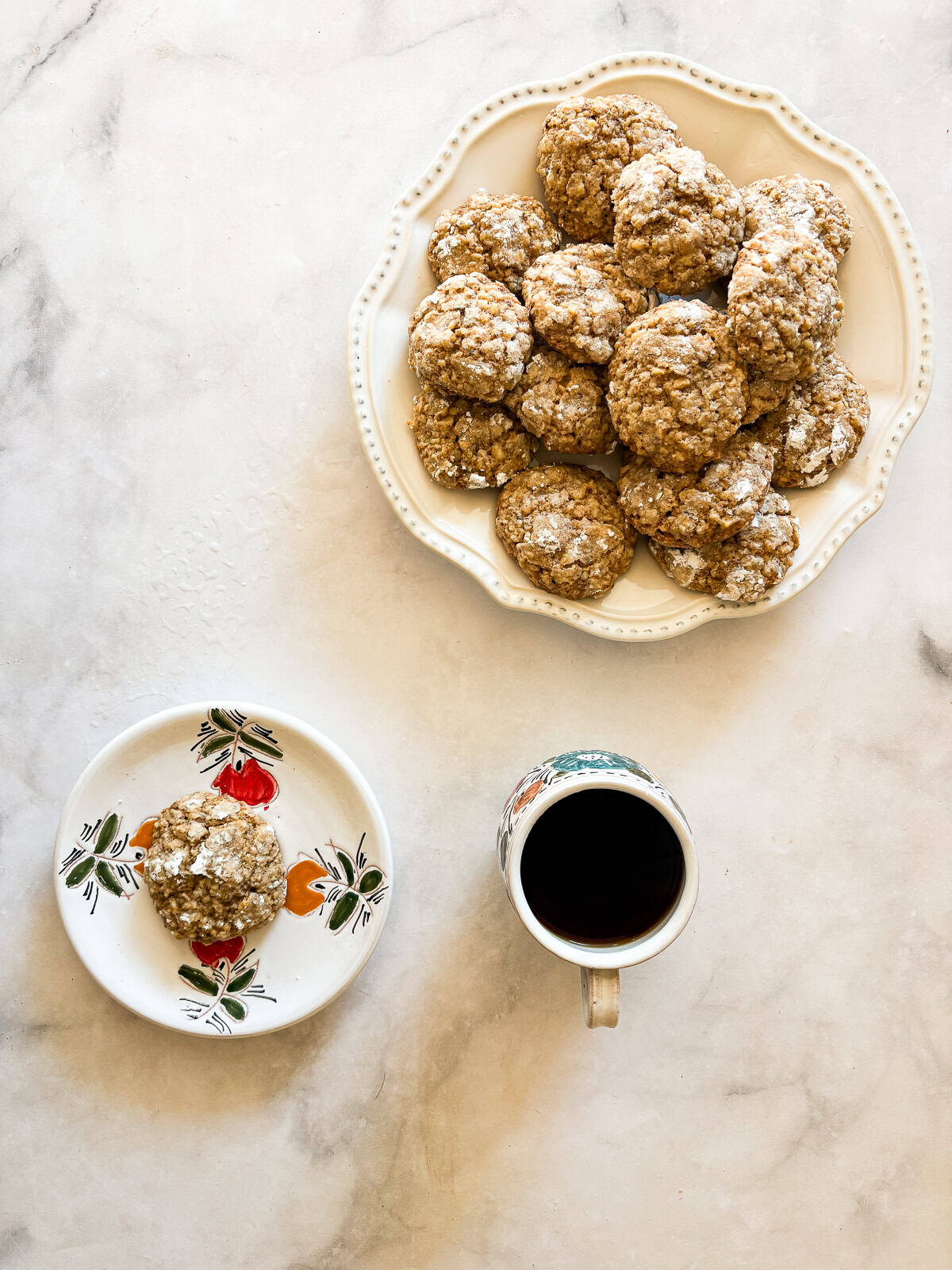 Chewy Moroccan ghriba cookies with walnuts and cinnamon are lightly sweet, rolled in powdered sugar, and easily gluten-free. A plate of ghriba, one cookie on a plate, and a cup of tea.