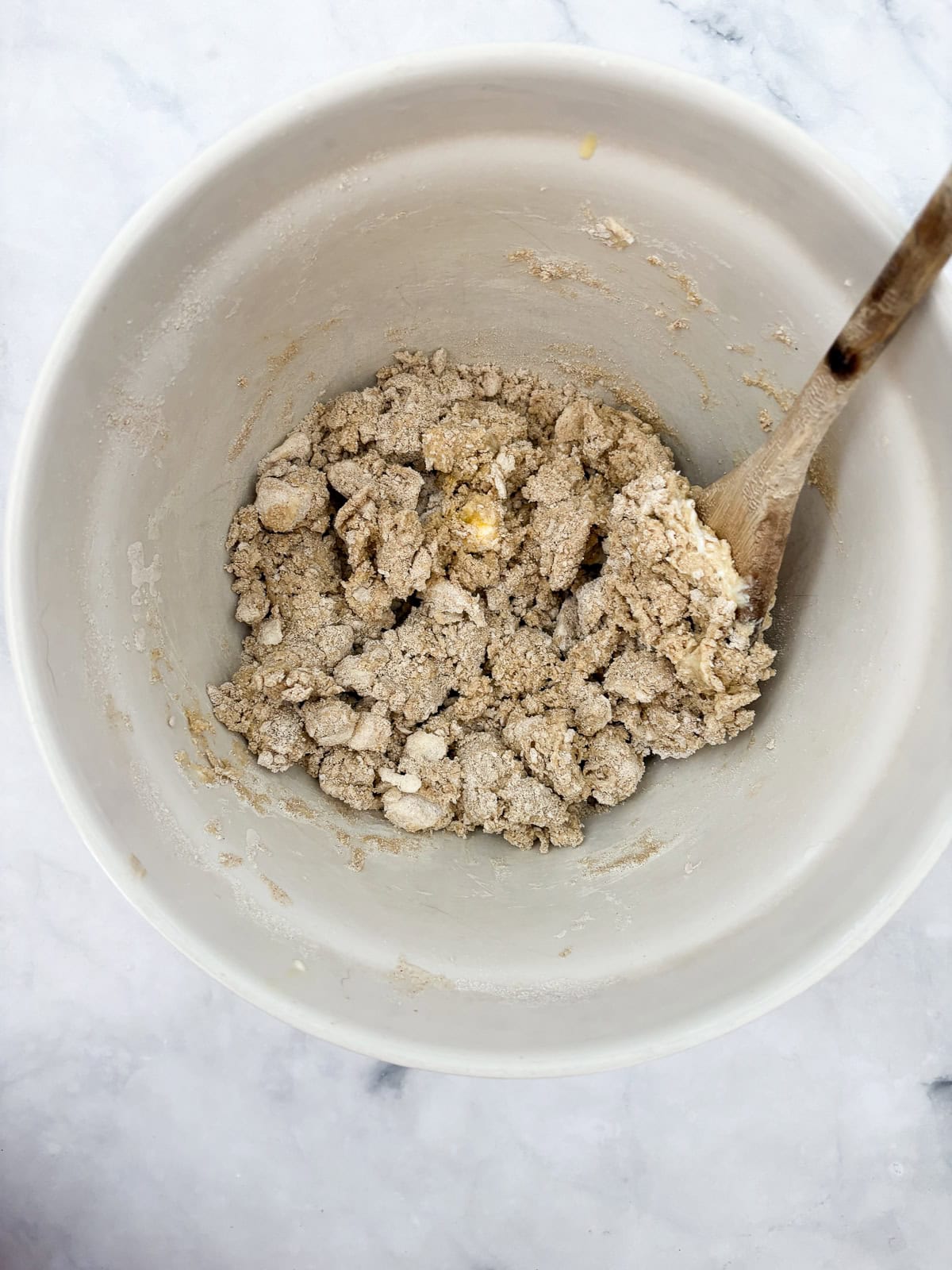 Bakery-style gluten-free chocolate chip scones with crisp edges, soft centers, and plenty of chocolate. Made just with oat flour! Dough for gluten free chocolate chip scones is stirred in a bowl.
