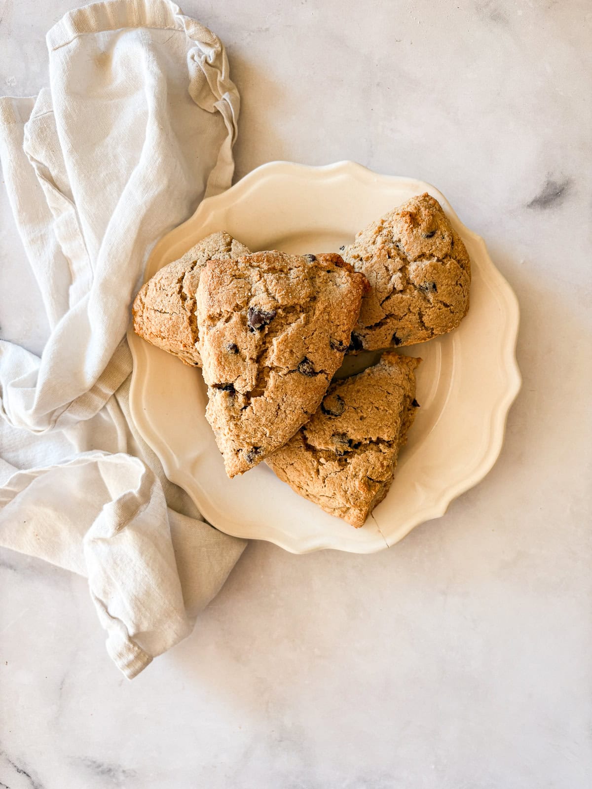 Gluten free chocolate chip scones on a plate with a napkin.