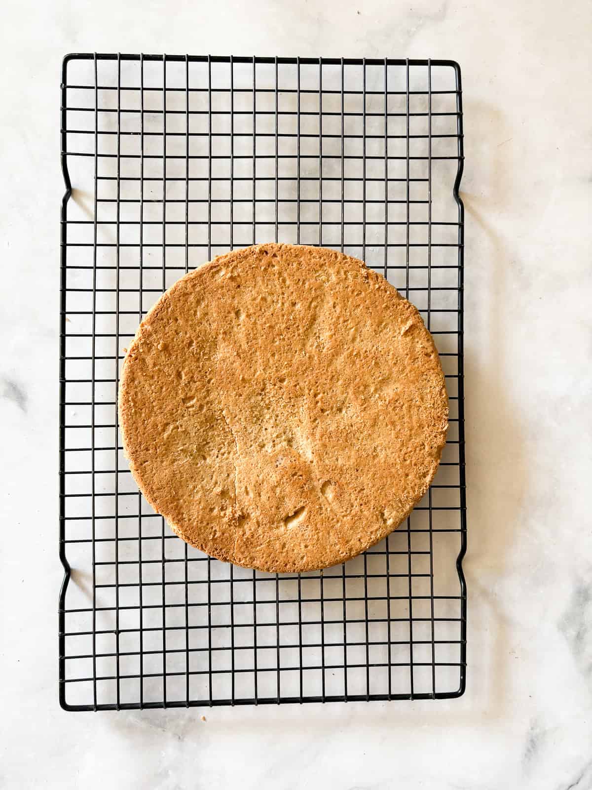Melt-in-your-mouth gluten free lavender shortbread cookies are made with plenty of butter and infused with a bit of fresh or dried lavender. A round of gluten free lavender sugar cookies cools on a rack.