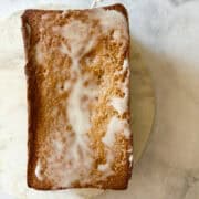 A gluten free lemon pound cake on a marble slab.
